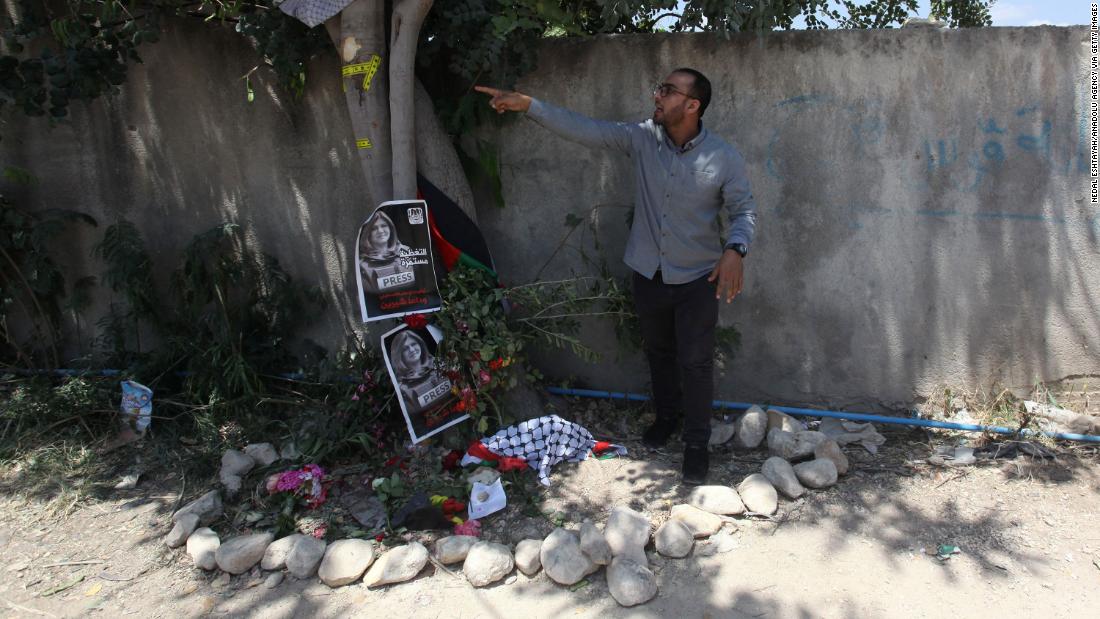 Palestinian journalist Mujahid al-Saadi, who was with Abu Akleh when she was killed, points to bullet marks on the tree in Jenin where she died.