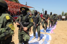 Islamic Jihad fighters step on replicas of Israeli and US flags during a graduation ceremony [File: Suhaib Salem/Reuters]