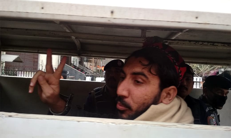 In this file photo, PTM chief Manzoor Pashteen gestures as police shift him from Peshawar's Judicial Complex. — Photo provided by Sirajuddin/File