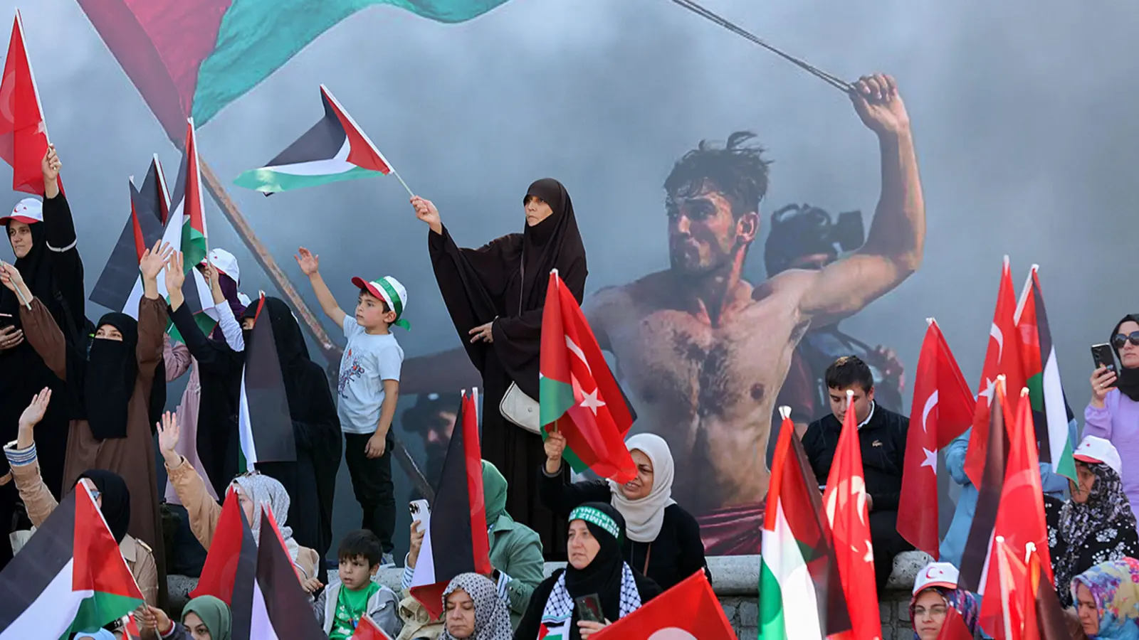 Demonstrators in Ankara wave Turkish and Palestinian flags during a rally in solidarity with Palestinians on October 14, 2023..