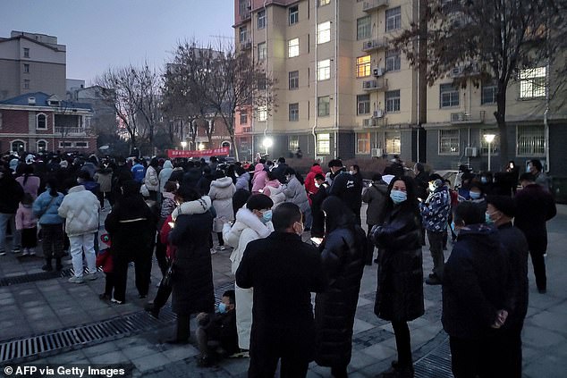 Authorities in Anyang announced the lockdown late Monday, issuing a notice ordering residents not to leave their homes or drive cars on the roads, state news agency Xinhua reported. Pictured: People in Anyang queue to be tested for Covid-19, January 8, 2022