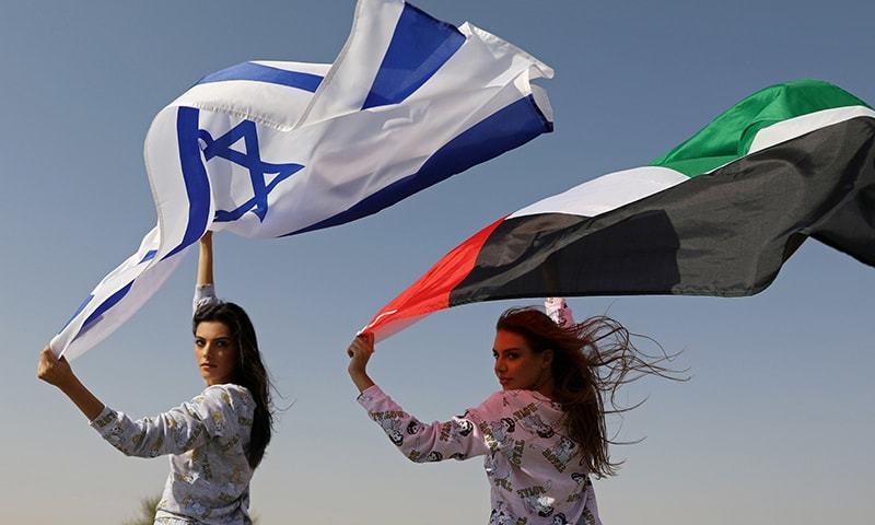 Israeli model May Tager, holding an Israeli flag, poses with Dubai-resident model Anastasia, holding an Emirati flag, during a photoshoot for FIX's Princess Collection in Dubai, UAE, on September 8, 2020. — Reuters/File