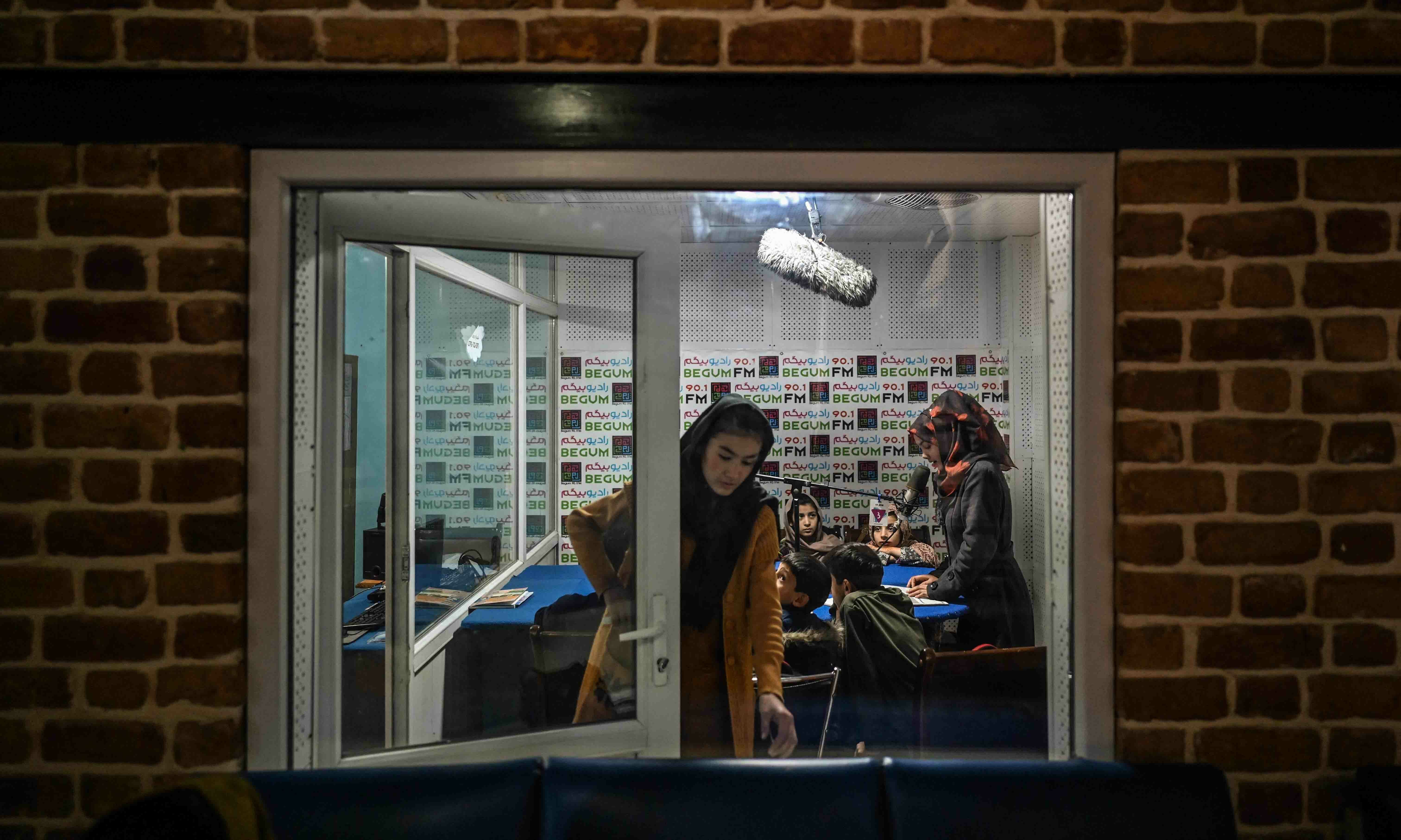 This picture taken on November 28 shows teachers and students attending a class on-air at Radio Begum in Kabul. — AFP