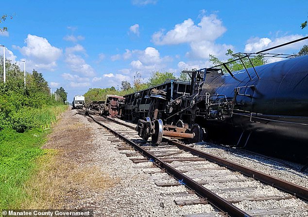 Authorities say five of the overturned train cars were carrying sheetrock and one was carrying propane fuel