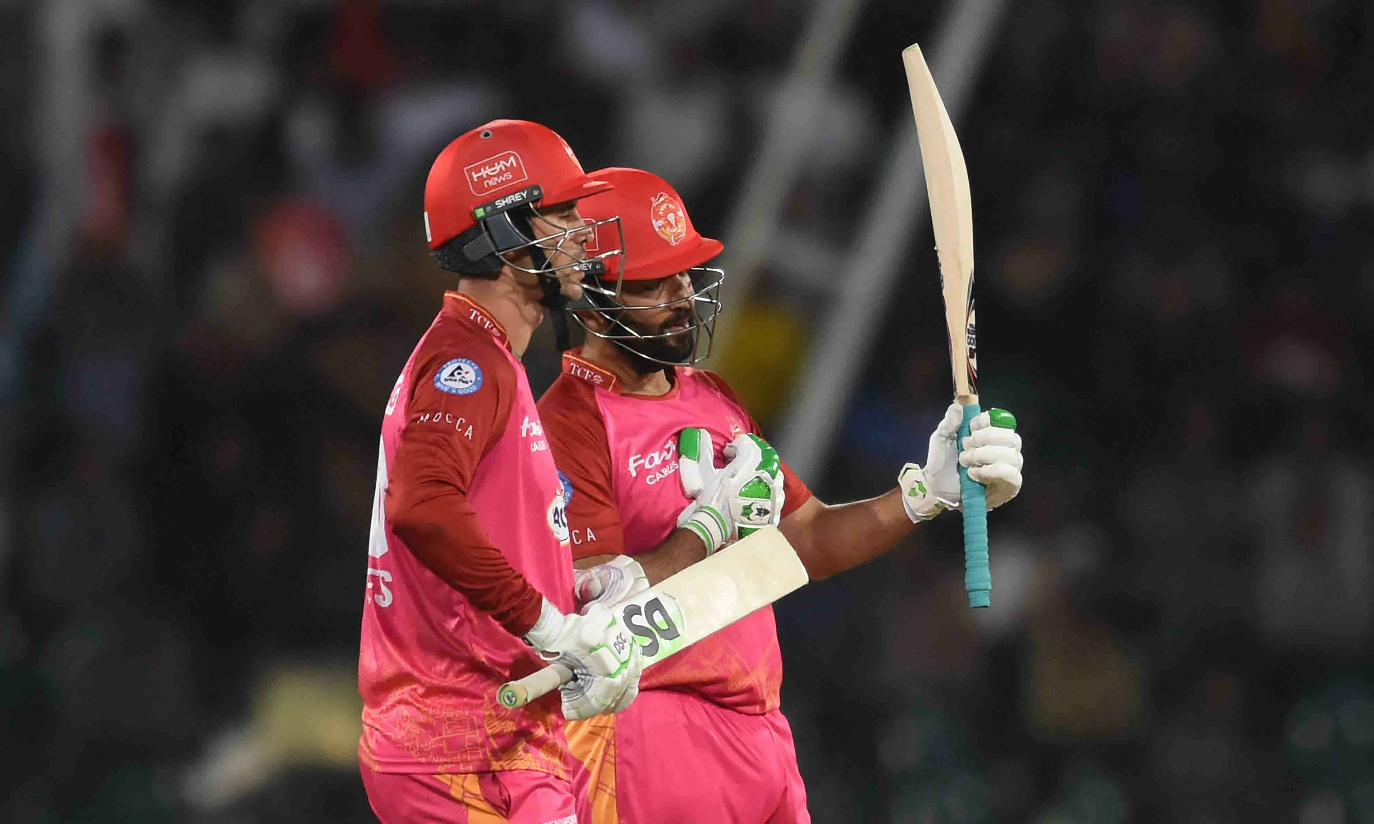 <p>Islamabad United’s Sohaib Maqsood (R) celebrates his fifty score (50 runs) next to Alex Hales (L) during the Pakistan Super League (PSL) Twenty20 cricket eliminator match between Peshawar Zalmi and Islamabad United at the Gaddafi Cricket Stadium in Lahore on March 16. — AFP</p>