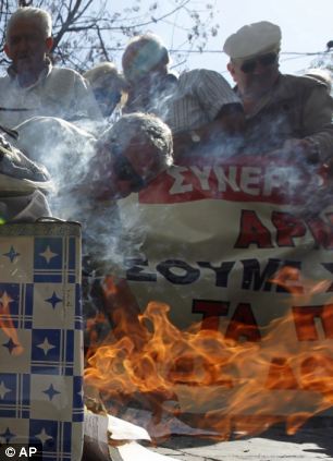 Civil unrest: Pensioners burn emergency tax notices during an anti austerity protest