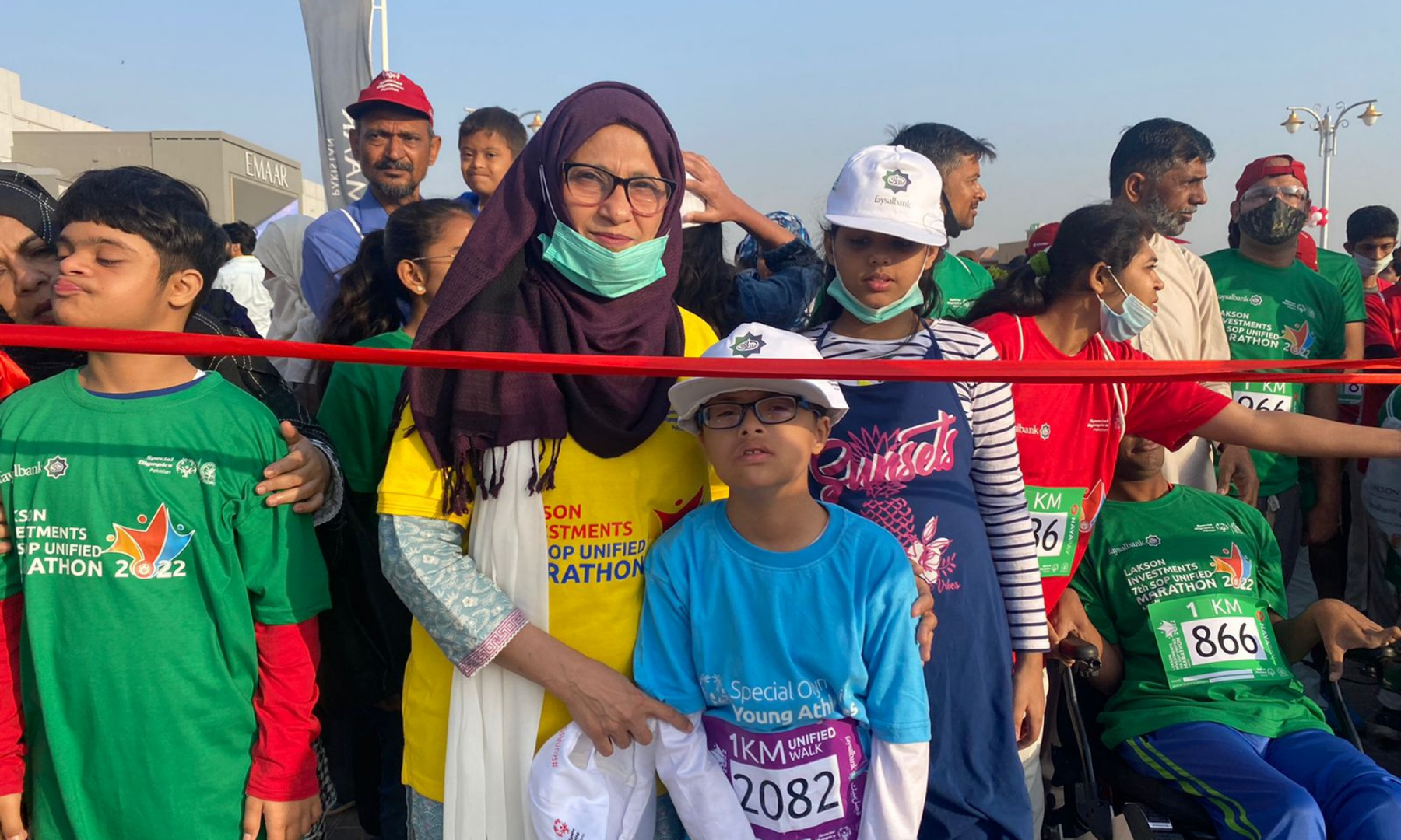 A mother holds on to her son at the starting line of the 1km unified walk at the 7th SOP Unified Marathon.