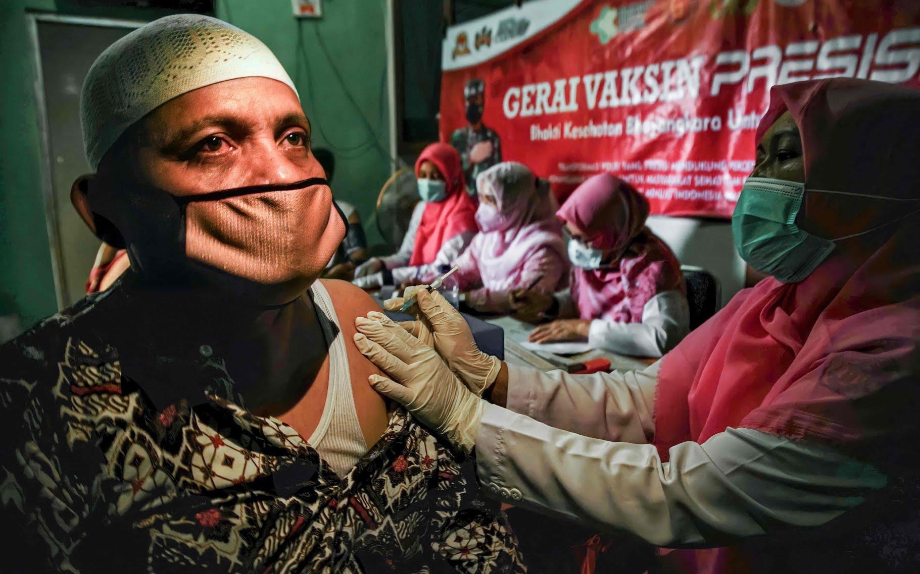 A man receives a dose of Sinovac's coronavirus vaccine during an inoculation drive in Pusong village, Lhokseumawe, Aceh