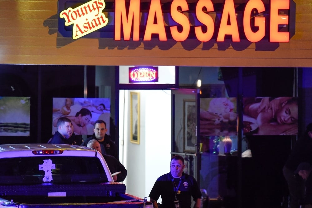 Authorities investigate a fatal shooting at a massage parlor on March 16 in Woodstock, Ga. —  AP