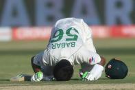 Pakistan's captain Babar Azam celebrates after reaching a century in Karachi (AFP/Rizwan TABASSUM)