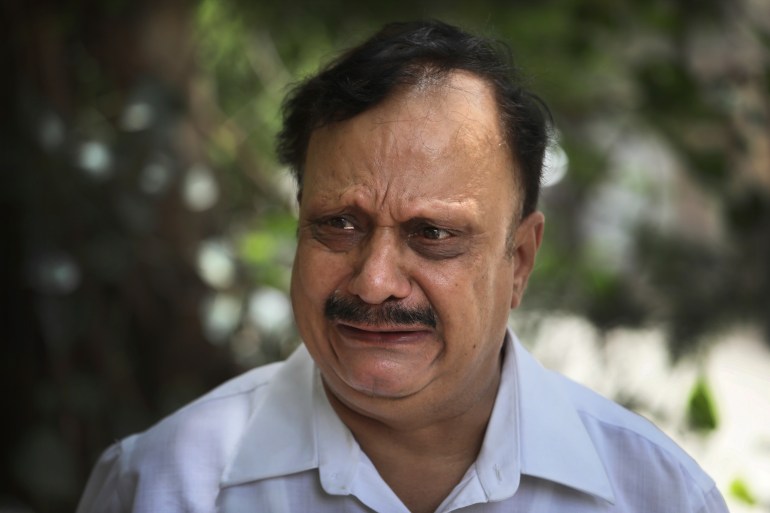 Anil Sharma breaks down while talking to the Associated Press after visiting his son, Saurav, who is being treated for COVID-19 at a private hospital in New Delhi [Manish Swarup/AP]