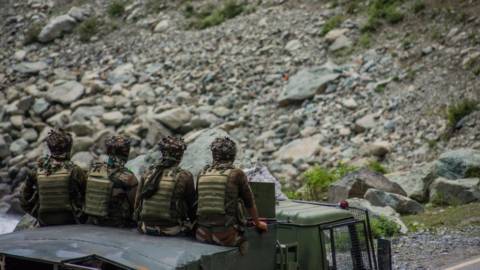 Indian army convoy carrying reinforcements and supplies, drive towards Leh, on a highway bordering China.