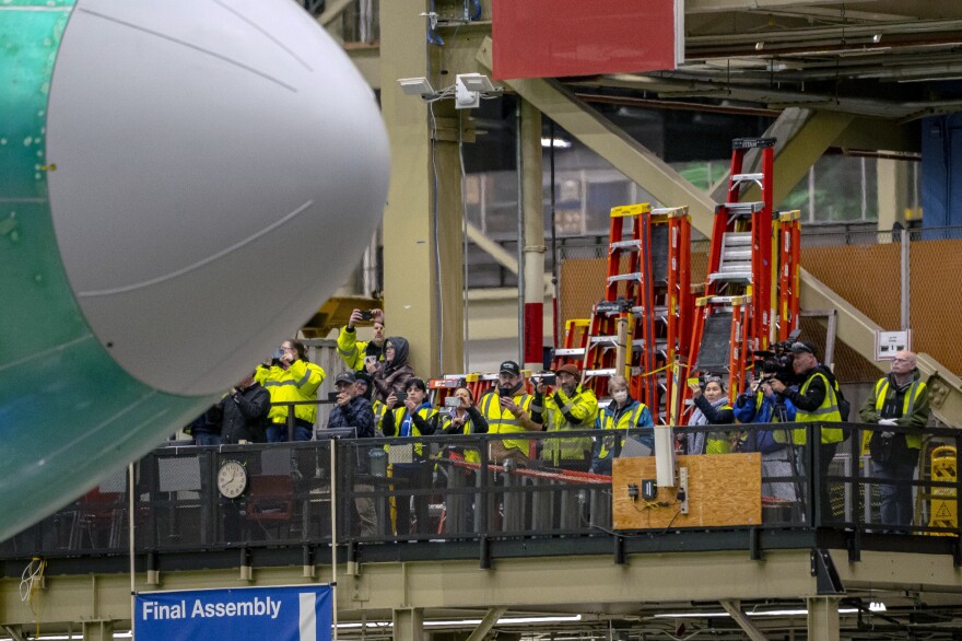 Employees watch a Boeing 747 during an event at the company's facility in Everett, Wash., on Tuesday.