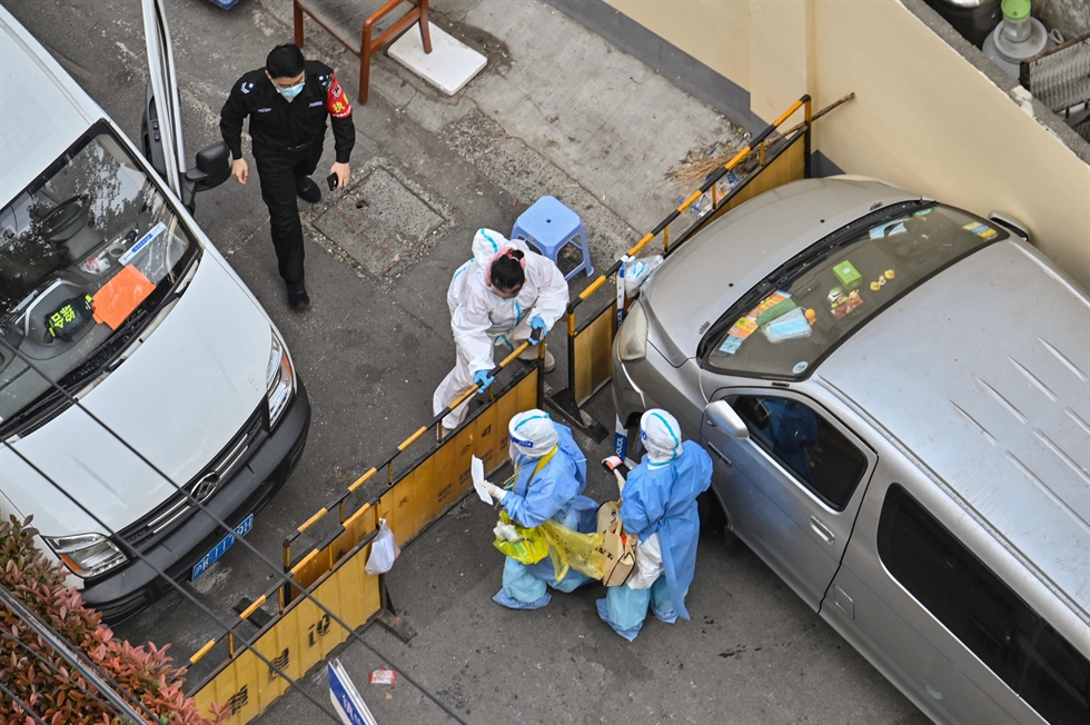                                                                                                  An employee working at a makeshift hospital that will be used for COVID-19 coronavirus patients in Shanghai in this April 7 photo. AFP-Yonhap                        