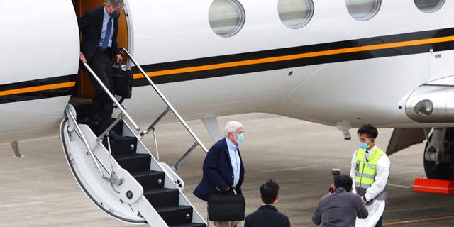 Former U.S. senator Chris Dodd, is followed by former U.S. Deputy Secretary of State James Steinberg as they disembark upon arrival in Taipei, Taiwan on Wednesday, April 14, 2021. (Pool Photo via AP)