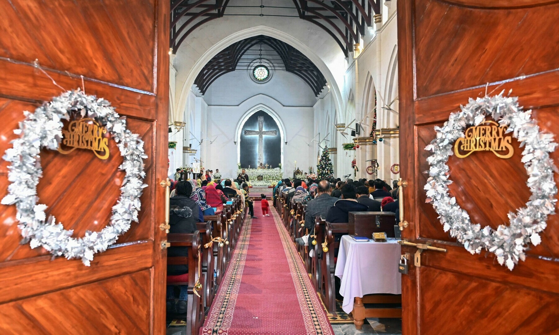 Christian devotees take part in a Christmas prayer at the St John’s Cathedral Church in Peshawar on December 25, 2022. — AFP