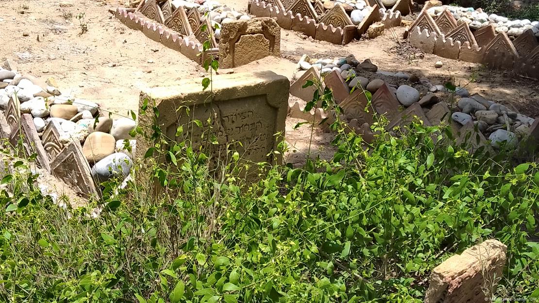 A Jewish gravestone overgrown with grass in Karachi