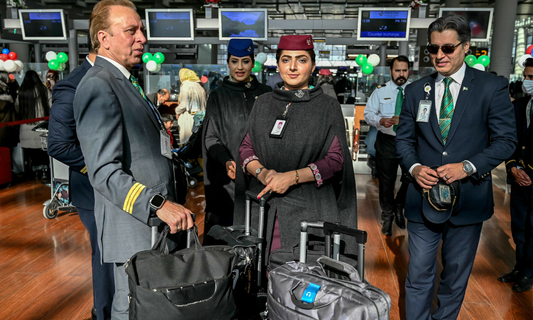 Pakistan International Airline (PIA) crew members arrive before boarding their flight to Paris at the Islamabad International Airport on Jan 10, 2025. — AFP