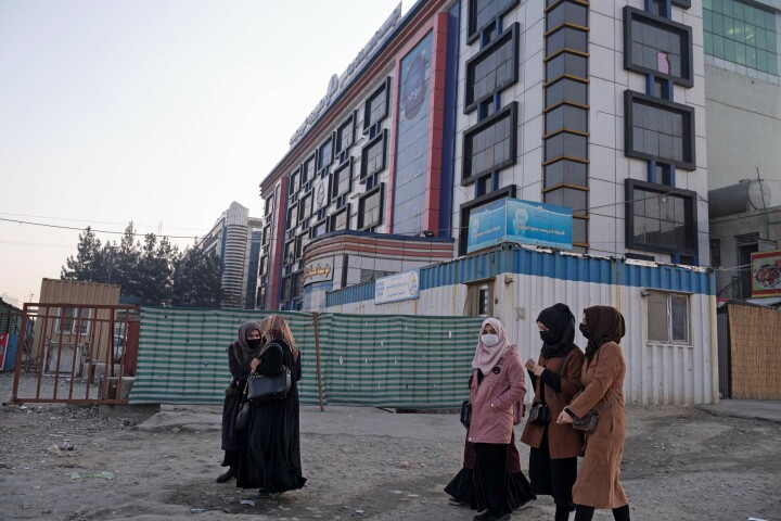  Afghan female university students walk on their on way back home past a private university in Kabul, Afghanistan on Dec 21. — AFP 