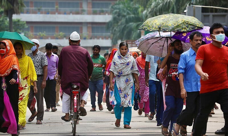 Garment workers come out of a factory during the lunch break as factories remain open despite a countrywide lockdown, in Dhaka, Bangladesh, July 6, 2021. — Reuters/File