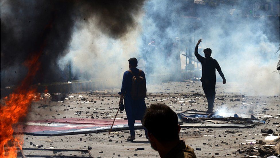 Pakistan Tehreek-e-Insaf (PTI) party activists and supporters of former Pakistan's Prime Minister Imran Khan, clash with police during a protest against the arrest of their leader in Peshawar on May 10, 2023