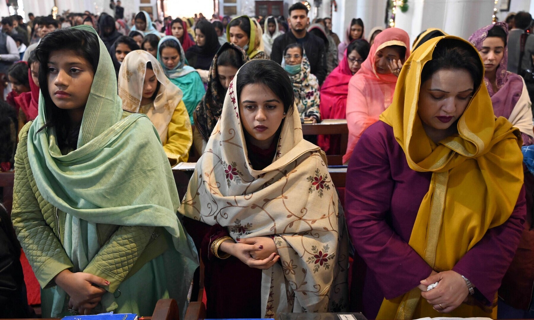 Christian devotees take part in a Christmas prayer at the St John’s Cathedral Church in Peshawar on December 25, 2022. — AFP