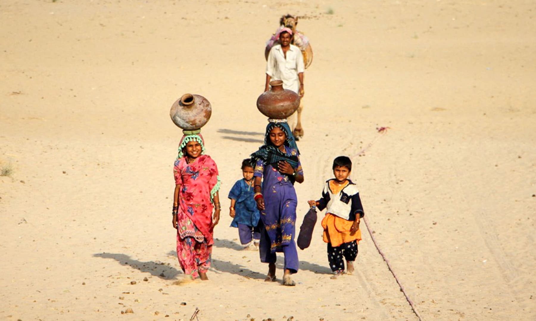 Women fetching water in Chhachhro taluka, Mithi, Sindh. — Photo by Umair Ali