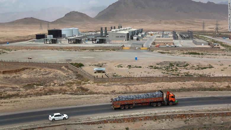 Traffic passes by the Tarakhil power plant in September 2011.