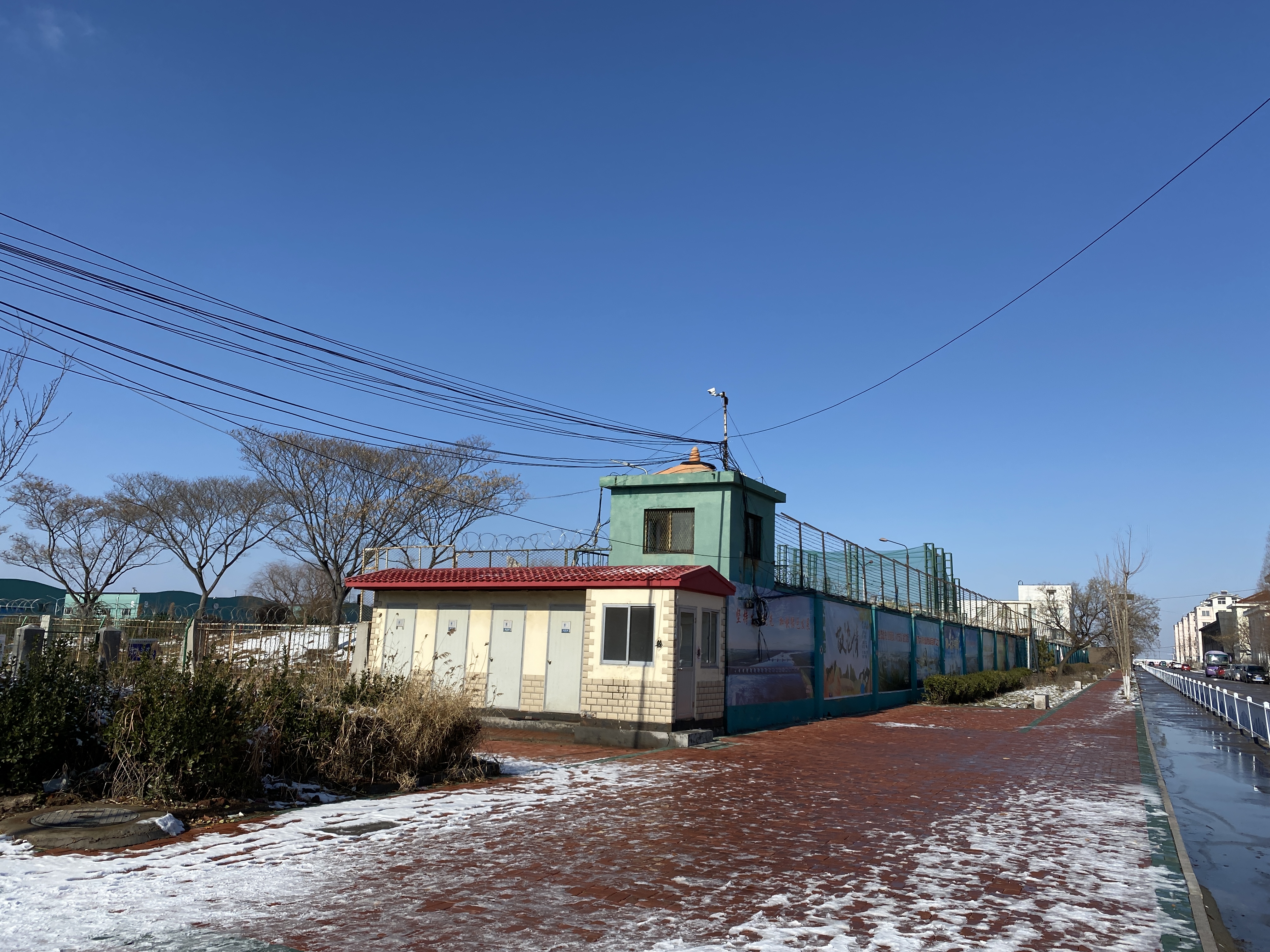 There are watchtowers with cameras pointed in all directions and high barbed wire fences atop the walls