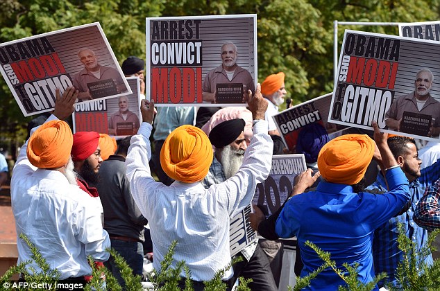 1412109973543_wps_47_Sikh_men_wave_banners_dem.jpg