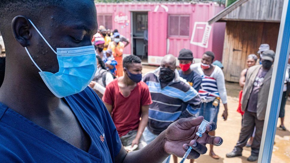 A health worker fills up a syringe with a Covid vaccine dose in Johannesburg on December 8, 2021.