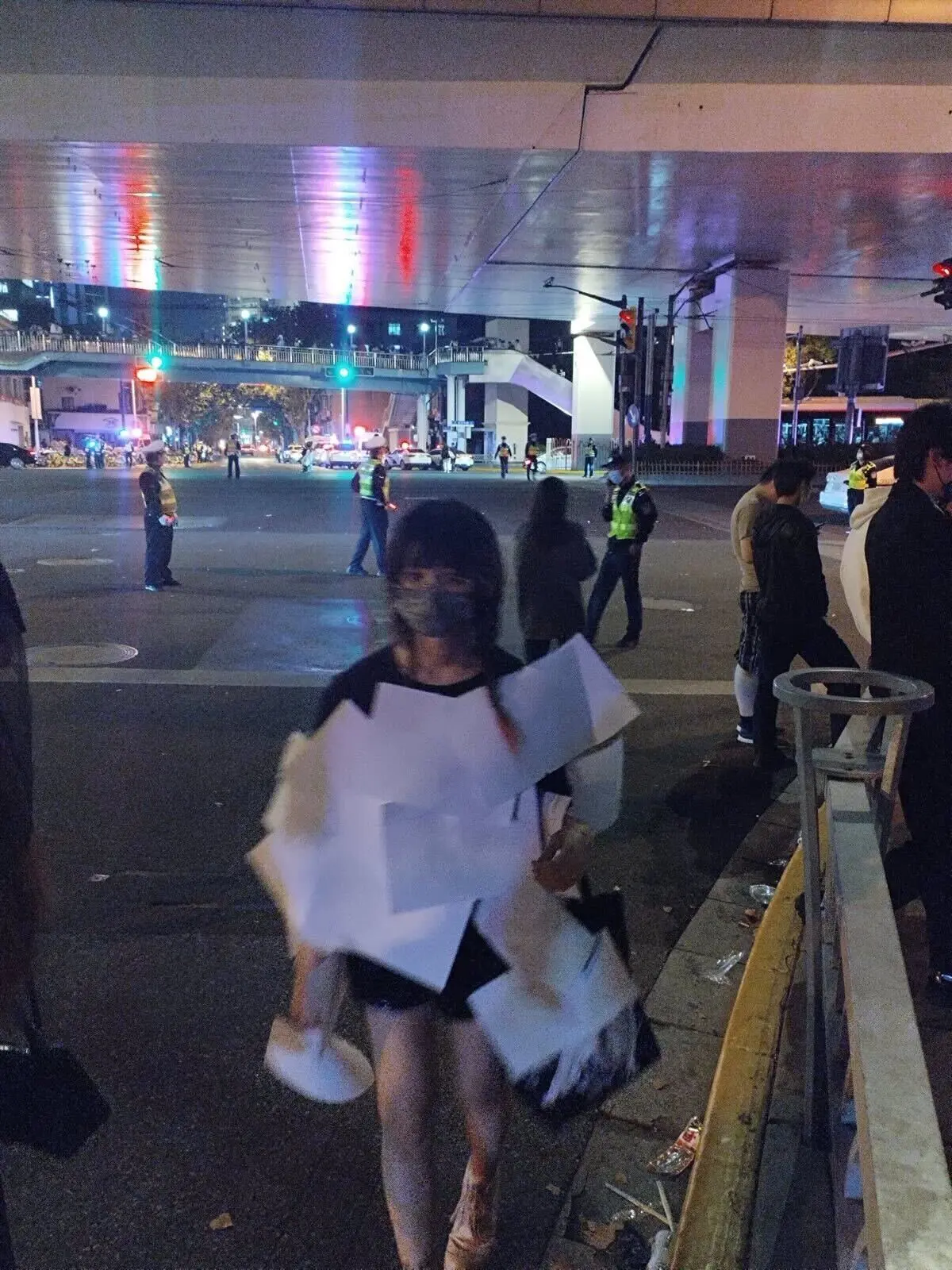 A woman dressed in a costume with blank sheets of paper attached to her shirt.