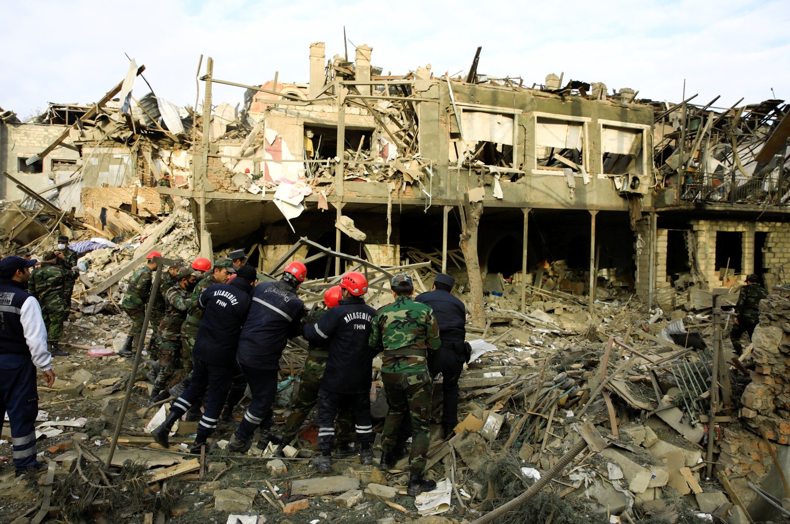 Search and rescue teams work on a blast site hit by an Armenian rocket, in the city of Ganja, Azerbaijan, Oct. 11, 2020. (Reuters Photo)