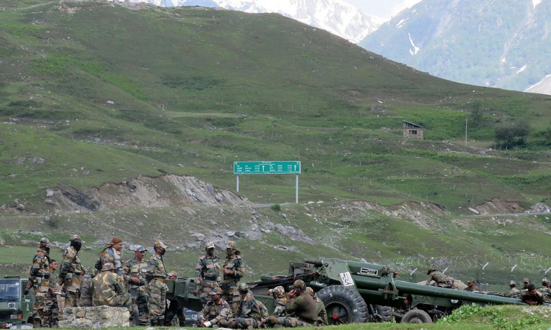 Indian army soldiers rest next to artillery guns at a makeshift transit camp before heading to Ladakh, near Baltal, southeast of Srinagar. — Reuters/File