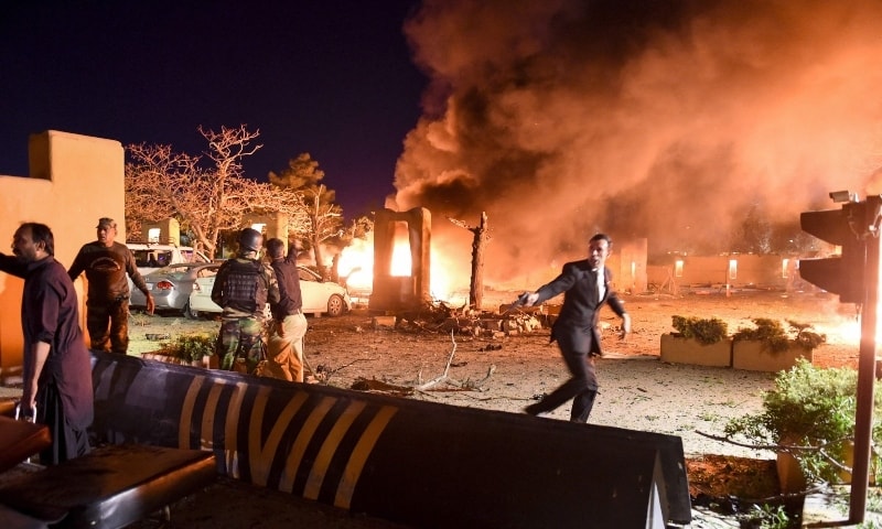 Security personnel and volunteers arrive at the site of an explosion in Quetta on April 21. — AFP