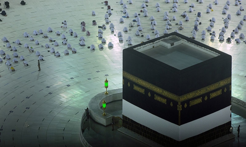 Pilgrims pray in front of the Kaaba as they keep social distancing at the start of the annual Hajj pilgrimage on Sunday. — AP