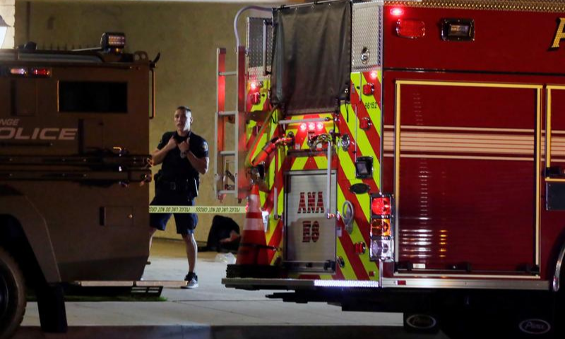 A police officer stands in front of a building after a shooting at an office building in Orange, California in the United States. — Reuters