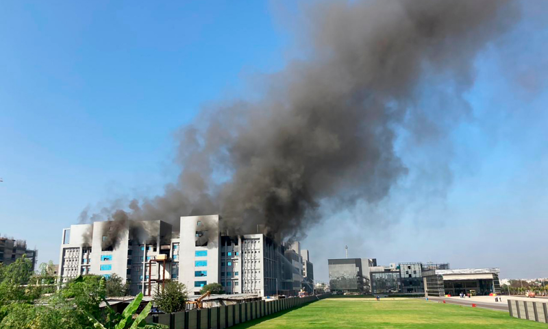 Smoke rises from the Serum Institute of India, the world's largest vaccine maker that is manufacturing the AstraZeneca/Oxford University vaccine for the coronavirus, in Pune, India on Thursday. — AP