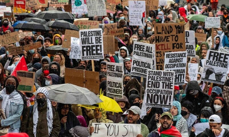  PEOPLE hold signs during a rally in support of Palestinians in Boston, Massachusetts.—AFP 