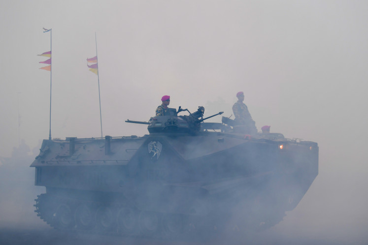 Marine Corps personnel of the Indonesian Navy observe the field from their LVTP-7A1 armored vehicle during a training exercise on Feb. 18, 2020.