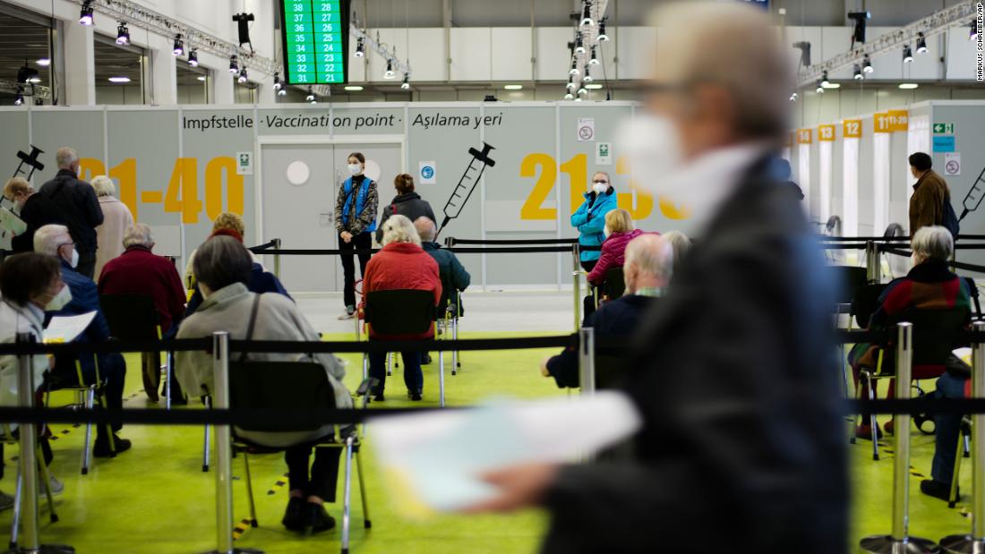 People wait to be vaccinated in Berlin, as Germany grapples with a rise in cases.