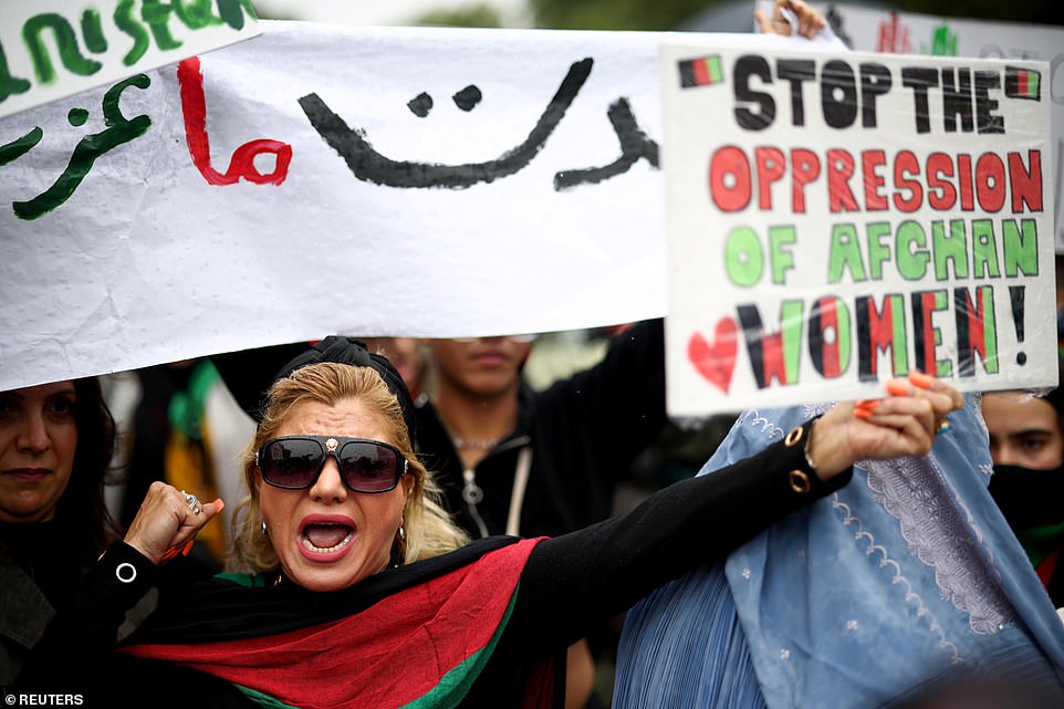 Protesters today braved the rain as they took to central London to call for Britain to do more to help stranded civilians and stand up to the terror group