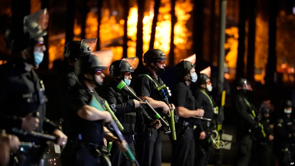 FILE - This March 24, 2021, file photo, Los Angeles police officers move in to arrest demonstrators in the Echo Park Lake homeless encampment in Los Angeles.