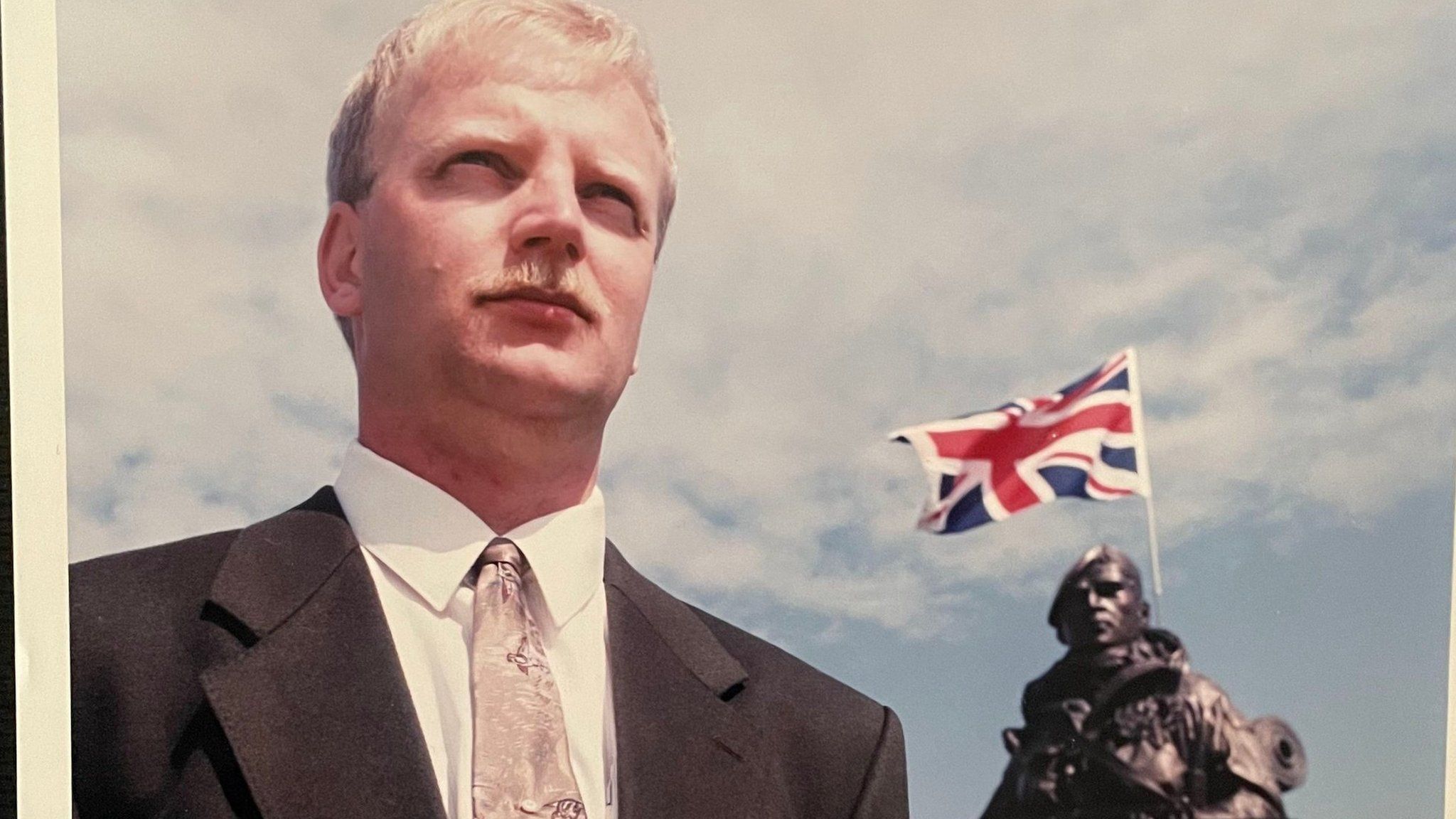 Peter Robinson beside the statue of the Yomper