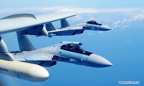 Two Su-35 fighter jets and a H-6K bomber fly in formation on May 11, 2018. The People's Liberation Army (PLA) air force conducted patrol training over China's island of Taiwan on Friday. Su-35 fighter jets flew over the Bashi Channel in formation with the H-6Ks for the first time, which marks a new breakthrough in island patrol patterns, said Shen Jinke, spokesperson for the PLA air force. (Xinhua/Liu Rui)