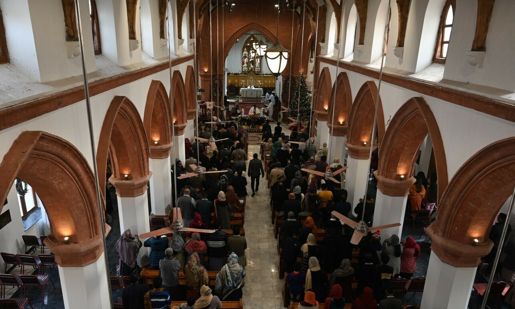 Christian devotees take part in a Christmas prayer at the Christ Church in Rawalpindi on December 25, 2022. — AFP