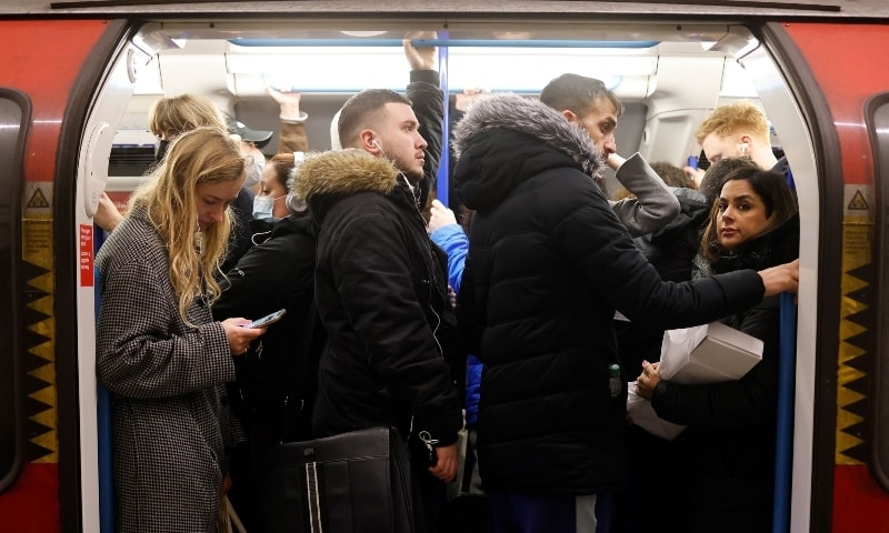 Commuters, some wearing face coverings due to Covid-19, crowd onto a Transport for London Underground tube train as they leave from central London in the evening rush hour on February 14. — AFP