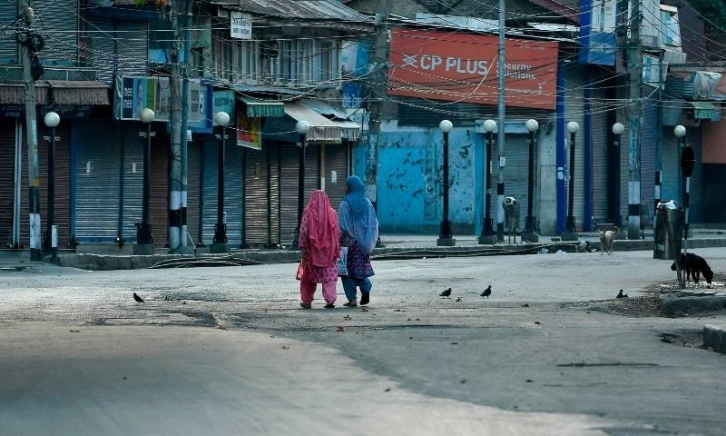 Women walk before a curfew in Srinagar on August 4, 2020. — AFP/File