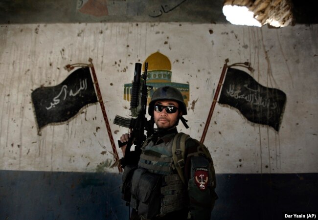 A commando of the Afghan National Army undergoes training by U.S. forces near Kabul in 2011.