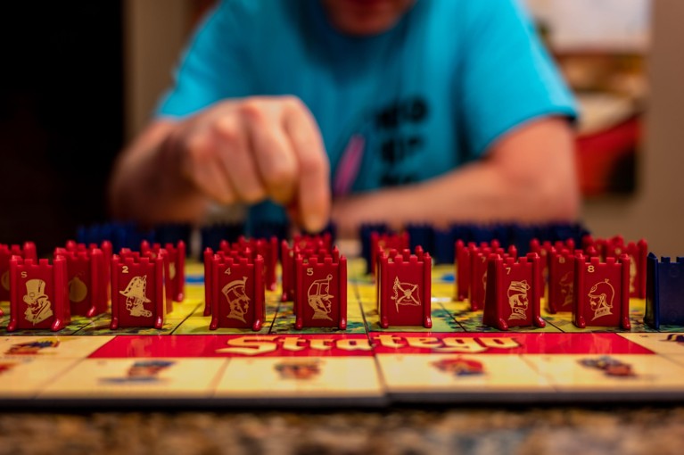 Close-up view of someone playing the Strategy board game